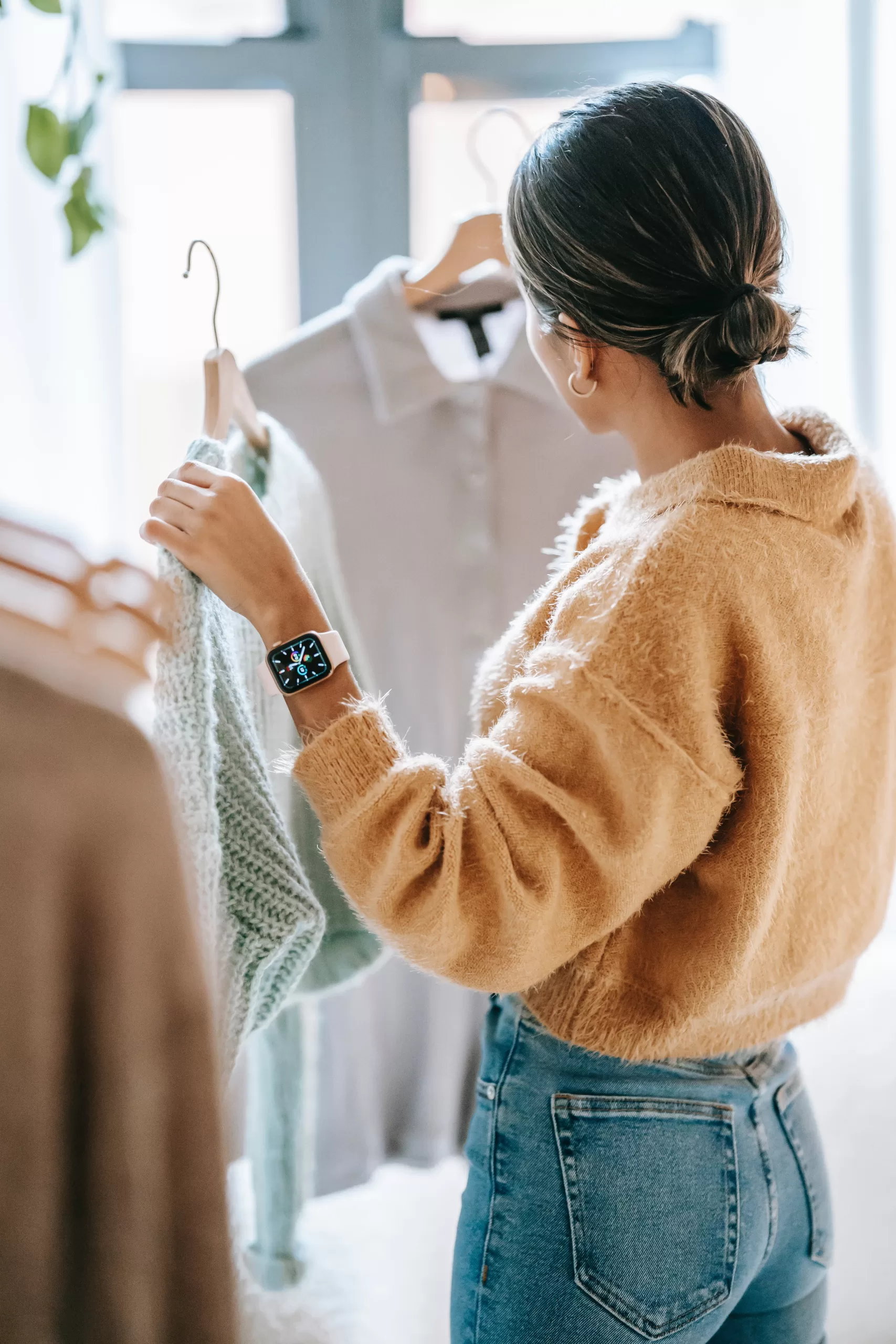 woman selecting clothes based on color