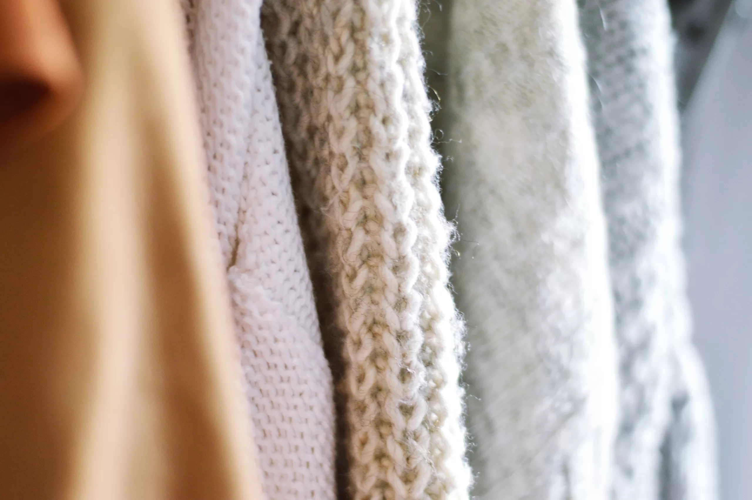 sustainable natural fabric sweaters hanging